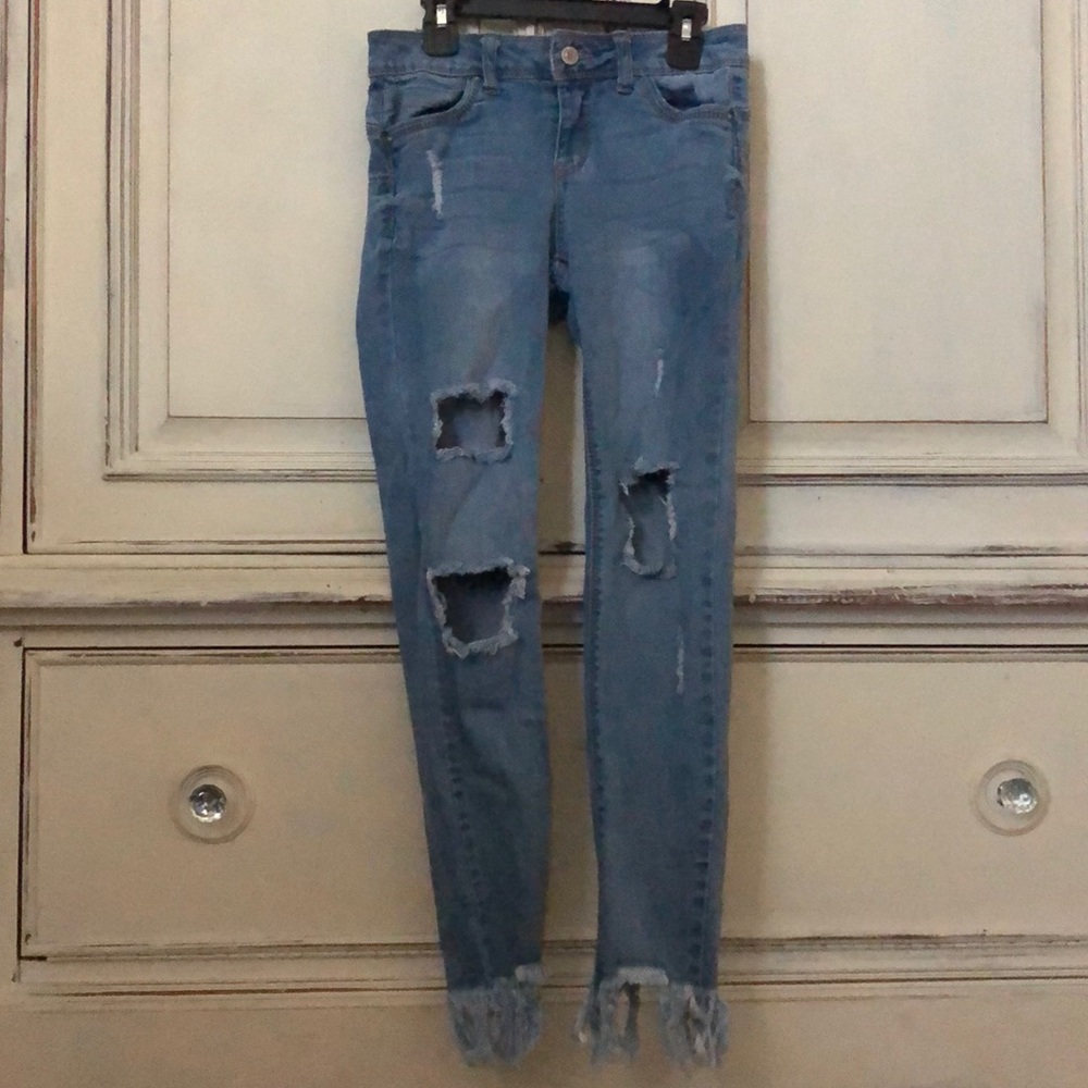 Ripped jeans frayed at the bottom